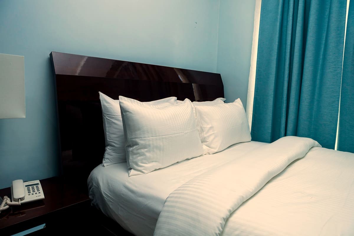 Pressed linen and pillows in a Deluxe Comfort room