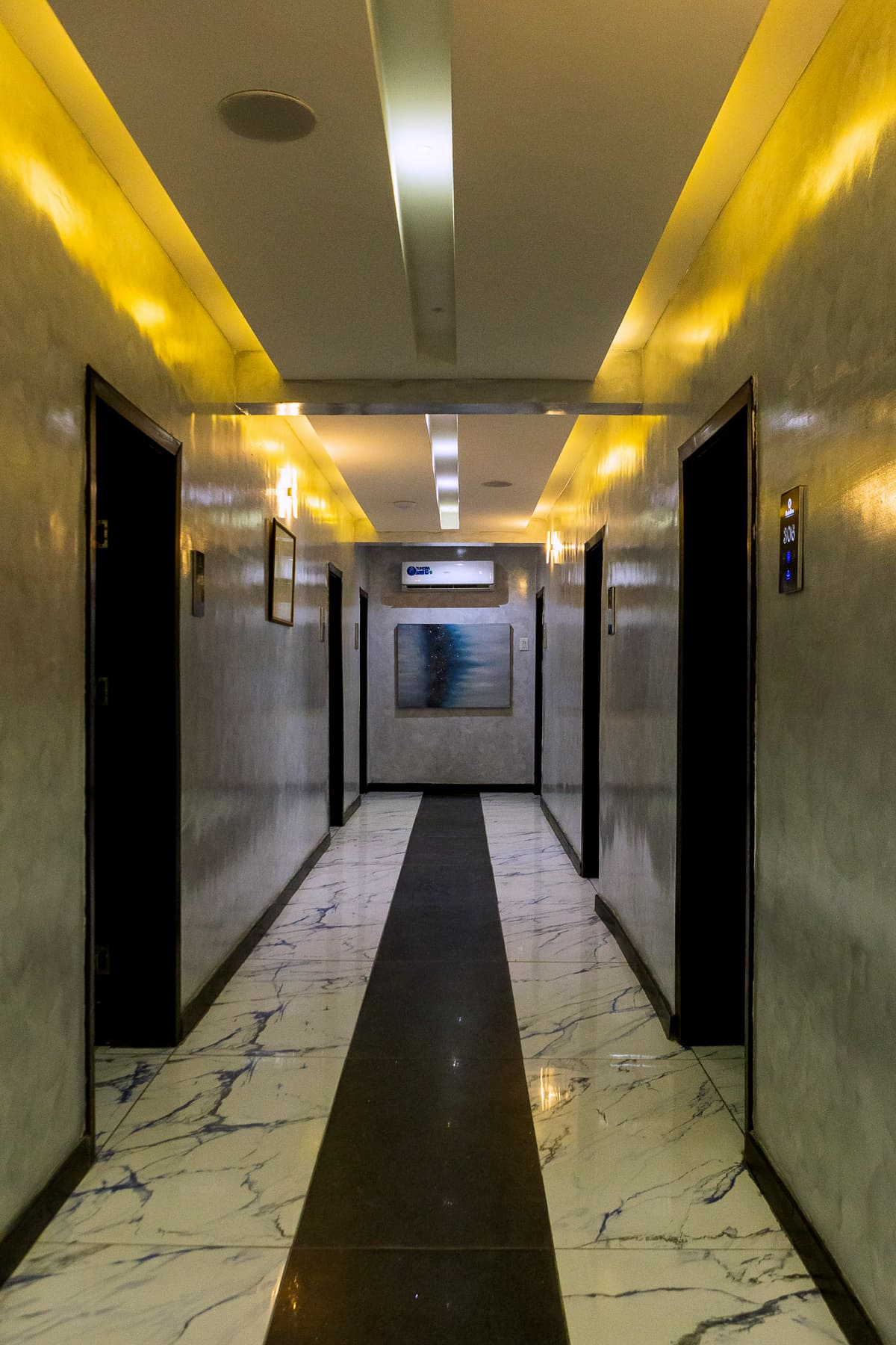 A quiet marble corridor at Hotel Medallion