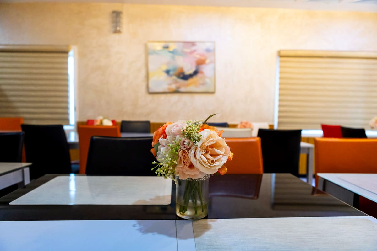 Fresh flowers on a laid table in the restaurant