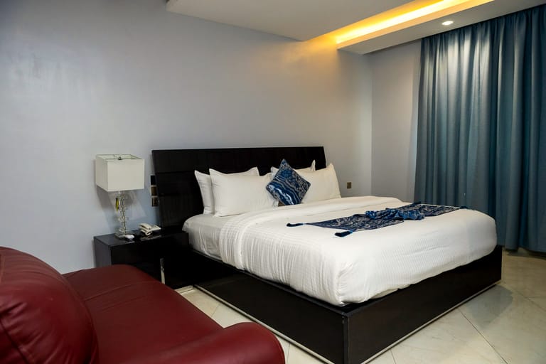 1 Bedroom Deluxe Suite — king bed and sitting area