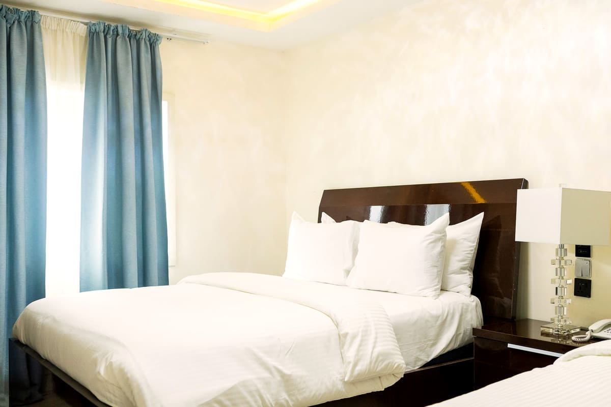 A Deluxe Comfort bed beside the window